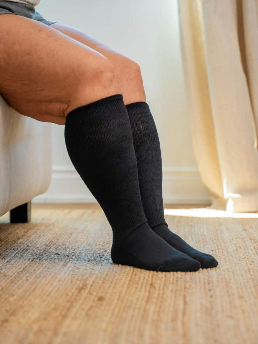 Black EasyStretch™ socks worn while seated