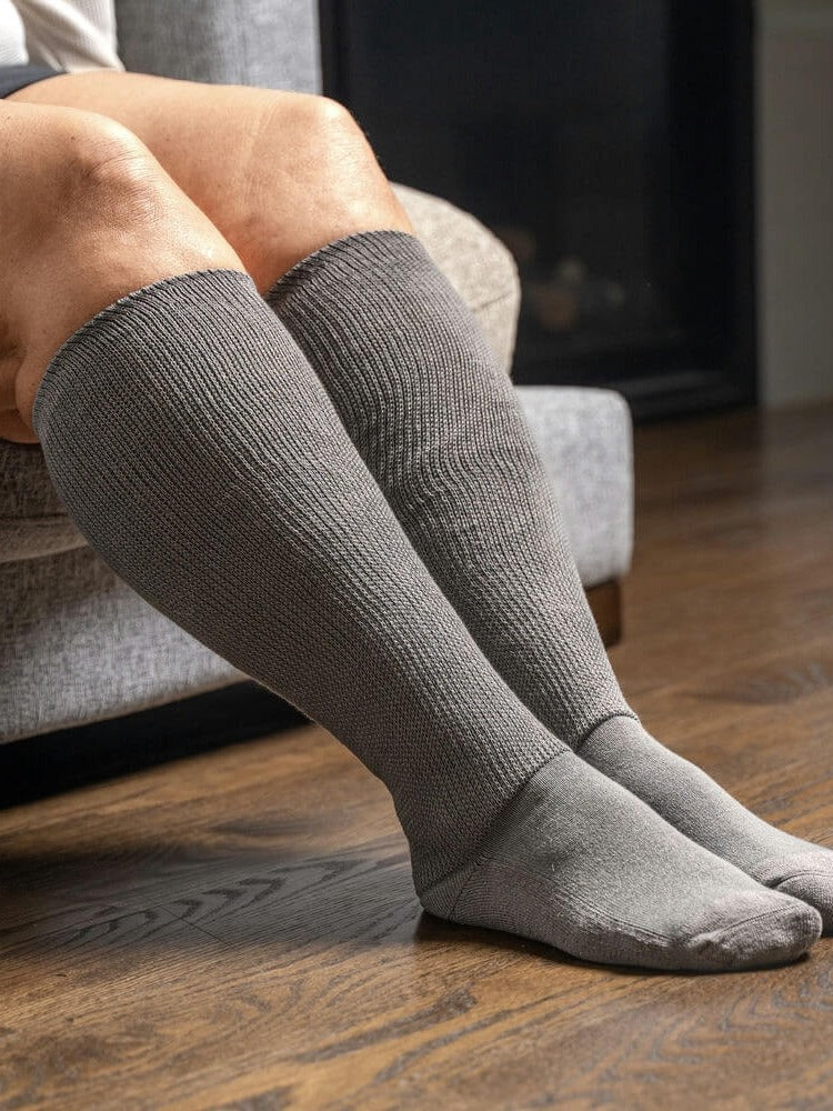 Gray EasyStretch™ socks worn while seated