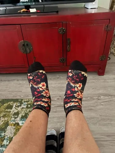 Dark red floral Ankle Compression socks worn with feet up