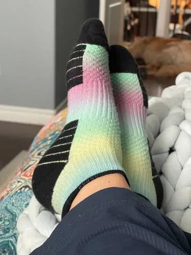 Rainbow gradient Ankle Compression socks worn while seated