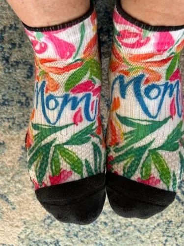 Floral Mom-lettering Ankle Compression socks worn on a blue rug
