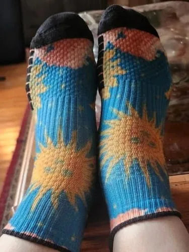 Teal sun-pattern Ankle Compression socks worn with feet raised