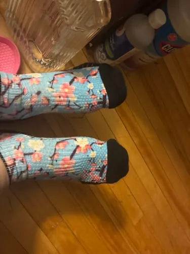 Cherry blossom Ankle Compression socks worn on a wood floor
