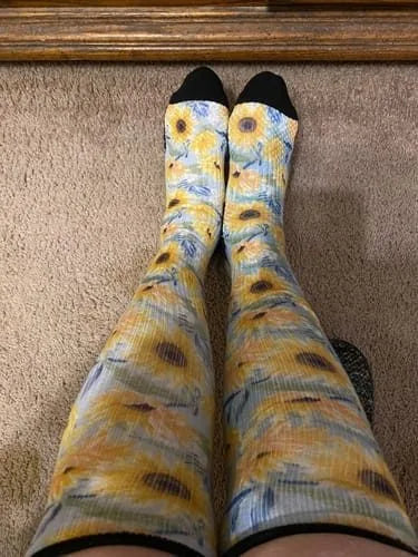 Sunflower-pattern Compression socks worn with legs stretched out