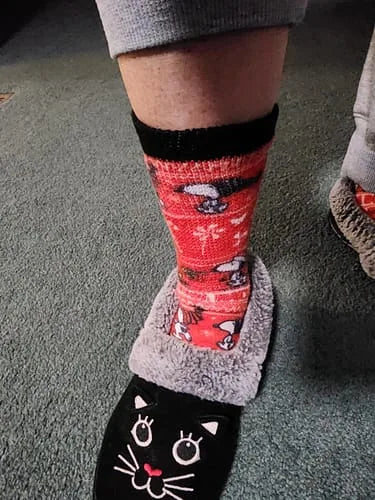Red cat-pattern EasyStretch™ socks worn with cat slippers, side view