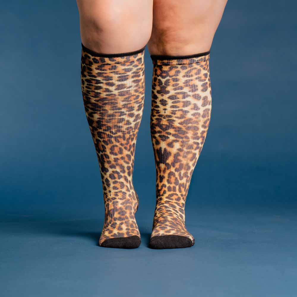A person wearing cheetah compression socks